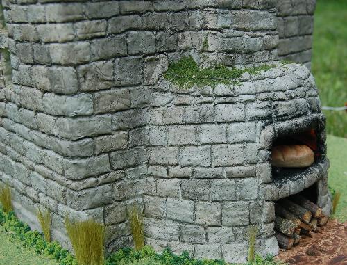 DSC_0012.JPG - The bread oven is accessible from the inside or outside. Wood heats the oven to an even temperature and then the dough is place in the oven to bake.