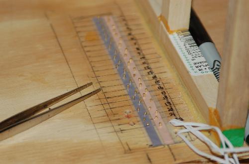 Sept23.JPG - I use brads to attach the round wire to the tape. I put in 44 tiny brads. Use an awl to make a hole for the brad first and it goes much easier. Then place with tweezers and use a small hammer to push in.