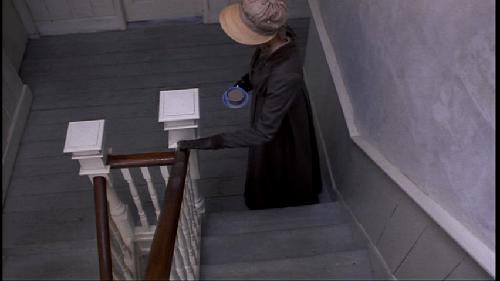 DVD_VIDEO-70.jpg - White posts and spindles. Stained handrail. And there's that gray floor again.