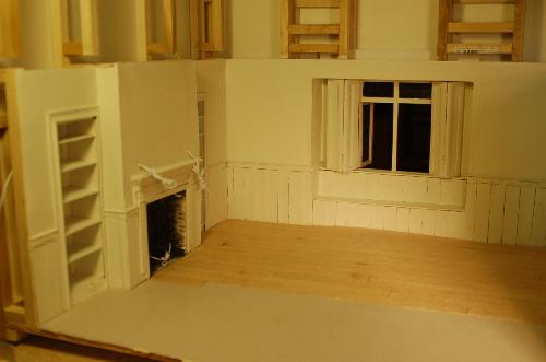 Woodwork002.JPG - The shutters are attached and the first coat of paint is applied to the dining room. I've started the floor in the dining room attaching the veneer strips to mattboard for possible removal in the future.