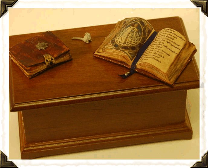 books.gif - Along with some supplies including faux leather, material, and landscaping materials, I purchased some books for my upcoming witch's cottage and some cranberry glass for my collection.